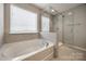 Bright bathroom with a large soaking tub and a glass-enclosed shower, providing a luxurious experience at 2076 Brightflower Ln, York, SC 29745