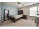 Bedroom featuring carpet flooring, a ceiling fan, natural lighting, and an accent wall at 2076 Brightflower Ln, York, SC 29745