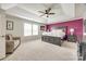 A bedroom featuring a tray ceiling, ceiling fan, carpet floors, and an accent wall at 2076 Brightflower Ln, York, SC 29745