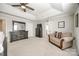 Bedroom with tray ceiling, carpet flooring, and a cozy chair at 2076 Brightflower Ln, York, SC 29745