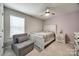 Bedroom with a neutral color palette, ceiling fan, and a cozy chair at 2076 Brightflower Ln, York, SC 29745