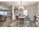 Elegant dining area with a stylish chandelier, a round table, and views into the living room at 2076 Brightflower Ln, York, SC 29745