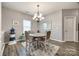 Bright dining space with modern light fixture, stylish table, and view of the backyard at 2076 Brightflower Ln, York, SC 29745