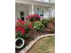 Charming home featuring lush rose bushes in red, pink, and yellow hues, adding vibrant color to the landscape at 2076 Brightflower Ln, York, SC 29745