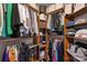 Walk-in closet with custom shelving and rods for organized storage, maximizing space and functionality at 210 N Church St # 1413, Charlotte, NC 28202
