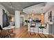 Open-concept living area flows from kitchen to dining and bedroom, featuring concrete ceilings at 210 N Church St # 1413, Charlotte, NC 28202
