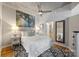 Bright bedroom with hardwood floors, a queen bed, nature art and a view to the on-suite bathroom at 210 N Church St # 1413, Charlotte, NC 28202