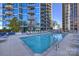 Large rooftop pool area, offers sun loungers and an inviting pool, surrounded by modern buildings for a relaxing urban retreat at 210 N Church St # 1413, Charlotte, NC 28202