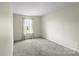 Bedroom features neutral paint, plush carpet, and natural light at 2177 Galloway Sw Ln, Concord, NC 28025