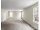 Spacious bonus room with plush carpet, multiple windows, and a convenient doorway at 2177 Galloway Sw Ln, Concord, NC 28025