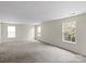 Large bonus room with plush carpet and ample natural light from multiple windows at 2177 Galloway Sw Ln, Concord, NC 28025