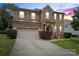Charming two-story brick home with attached garage, landscaped yard and inviting front entrance at 2177 Galloway Sw Ln, Concord, NC 28025