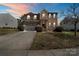 Charming two-story brick home featuring a well-maintained lawn and attached two-car garage with a wide driveway at 2177 Galloway Sw Ln, Concord, NC 28025
