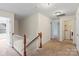 Spacious hallway with neutral carpet and access to the laundry room at 2177 Galloway Sw Ln, Concord, NC 28025