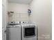 Bright laundry room featuring modern washer and dryer units at 2177 Galloway Sw Ln, Concord, NC 28025