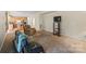 Cozy carpeted living room featuring comfortable seating and an entertainment center, next to a bright kitchen at 2177 Galloway Sw Ln, Concord, NC 28025