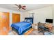 Bedroom featuring a plush blue bed, hardwood floors, and a functional workspace, perfect for relaxation and productivity at 2205 Centergrove Rd, Kannapolis, NC 28083