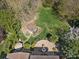 Aerial shot of landscaped backyard with outdoor kitchen, brick patio, fire pit, gazebo and mature trees at 2907 Blackburn Dr, Waxhaw, NC 28173