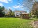 Expansive backyard featuring lush lawn, gazebo, mature trees, and meticulous landscaping at 2907 Blackburn Dr, Waxhaw, NC 28173