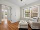 Bright bedroom features hardwood floors, a cozy chair, and a large sunny window at 2907 Blackburn Dr, Waxhaw, NC 28173