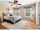 Cozy bedroom boasts a plush bed, decorative pillows, and bright windows with valances at 2907 Blackburn Dr, Waxhaw, NC 28173