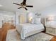 Comfortable bedroom with neutral tones, hardwood floors, soft area rug, and a well-lit ambiance at 2907 Blackburn Dr, Waxhaw, NC 28173