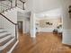 Bright foyer with hardwood floors, a staircase, and access to multiple living spaces at 2907 Blackburn Dr, Waxhaw, NC 28173