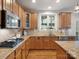 Well-lit kitchen features stainless steel appliances, granite countertops, and maple cabinets at 2907 Blackburn Dr, Waxhaw, NC 28173