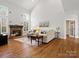 Inviting living room with a stone fireplace, hardwood floors, neutral decor, and large windows at 2907 Blackburn Dr, Waxhaw, NC 28173