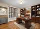Well-appointed office with wood flooring, built-in shelving, and a large window for natural light at 2907 Blackburn Dr, Waxhaw, NC 28173