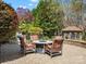 Inviting stone patio with a fire pit, comfortable seating, and a charming gazebo in a private yard at 2907 Blackburn Dr, Waxhaw, NC 28173