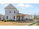 Large backyard with patio, outdoor seating, grill, and a play structure on a manicured lawn at 3013 Arsdale Rd, Waxhaw, NC 28173