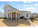 Spacious backyard with a covered patio, outdoor seating, grill, and well-maintained lawn at 3013 Arsdale Rd, Waxhaw, NC 28173