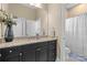 Well-lit bathroom with granite countertops, dark cabinetry, and a combined shower and tub at 3013 Arsdale Rd, Waxhaw, NC 28173