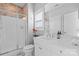 Bright bathroom with a glass door shower, white cabinets, and a large mirror above the sink at 3013 Arsdale Rd, Waxhaw, NC 28173
