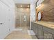 Bathroom with a tiled shower with a glass door, neutral color pallette, and plenty of storage at 3013 Arsdale Rd, Waxhaw, NC 28173
