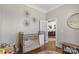 Charming Bedroom with hardwood floors, crib, and doorway into another room at 3013 Arsdale Rd, Waxhaw, NC 28173
