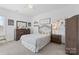 Neutral bedroom featuring carpet floors, dresser with mirror, and a decorative wall sticker at 3013 Arsdale Rd, Waxhaw, NC 28173