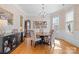 Elegant dining room with chandelier, decorative wallpaper, hardwood floors, and natural light at 3013 Arsdale Rd, Waxhaw, NC 28173