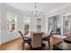 Bright dining room with hardwood floors, a chandelier, and views of the neighborhood at 3013 Arsdale Rd, Waxhaw, NC 28173