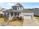 Charming two-story home with a welcoming front porch and well-maintained lawn at 3013 Arsdale Rd, Waxhaw, NC 28173