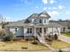 Attractive two-story home with a inviting front porch, garden, and manicured lawn at 3013 Arsdale Rd, Waxhaw, NC 28173