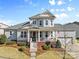 Charming two-story home with a welcoming front porch, American flag, and well-manicured lawn at 3013 Arsdale Rd, Waxhaw, NC 28173