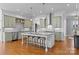 Bright kitchen features a large island with seating, stainless steel appliances, and hardwood floors at 3013 Arsdale Rd, Waxhaw, NC 28173
