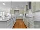 Bright, modern kitchen features marble countertops, stainless steel appliances, and hardwood floors at 3013 Arsdale Rd, Waxhaw, NC 28173