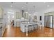 Bright kitchen features a large marble island with seating, stainless steel appliances, and hardwood floors at 3013 Arsdale Rd, Waxhaw, NC 28173
