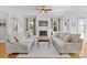 Bright living room features a fireplace, large windows, and comfortable seating at 3013 Arsdale Rd, Waxhaw, NC 28173