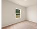 Bright, minimalist bedroom with neutral carpeting, white walls, and a scenic view from the window at 3254 Maple Ridge Dr, Gastonia, NC 28052