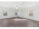 Bright bedroom featuring wood floors, ceiling fan, and lots of natural light from large windows at 3418 Saddlebred Dr, Gastonia, NC 28052