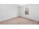 Bedroom featuring neutral colored carpet, white walls and window at 3418 Saddlebred Dr, Gastonia, NC 28052